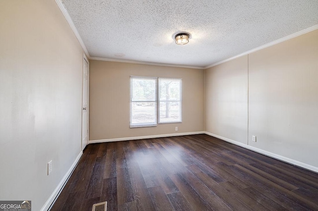 spare room featuring dark wood-type flooring, ornamental molding, and a textured ceiling