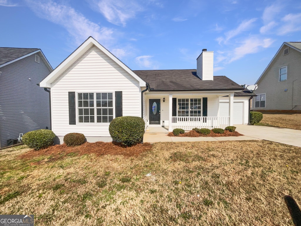 ranch-style home with a garage, covered porch, and a front lawn