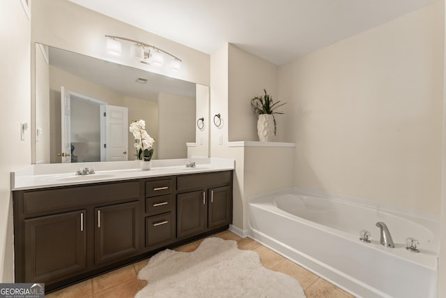 bathroom with vanity, tile patterned floors, and a tub