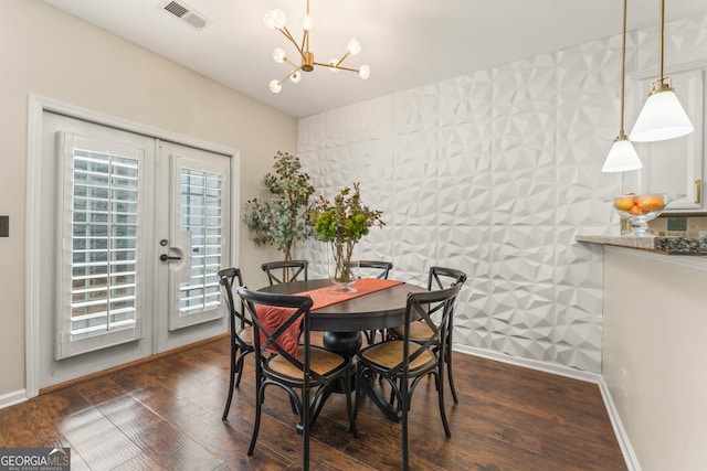 dining area featuring french doors, dark hardwood / wood-style flooring, and a chandelier