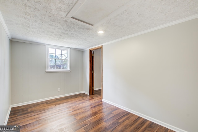 unfurnished room featuring ornamental molding, dark hardwood / wood-style floors, and a textured ceiling