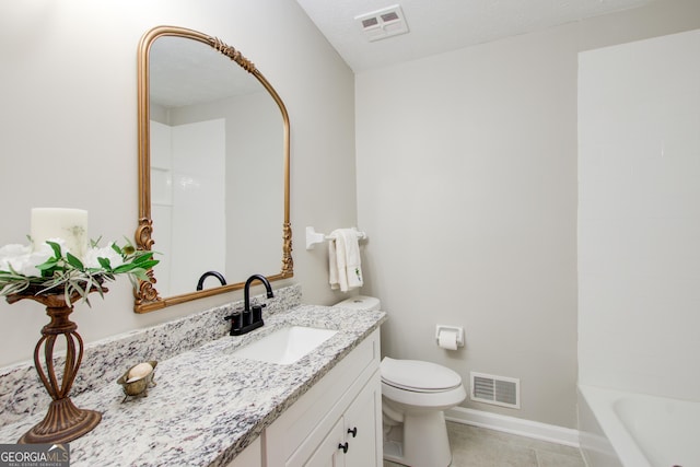 bathroom with vanity, a bath, a textured ceiling, tile patterned floors, and toilet