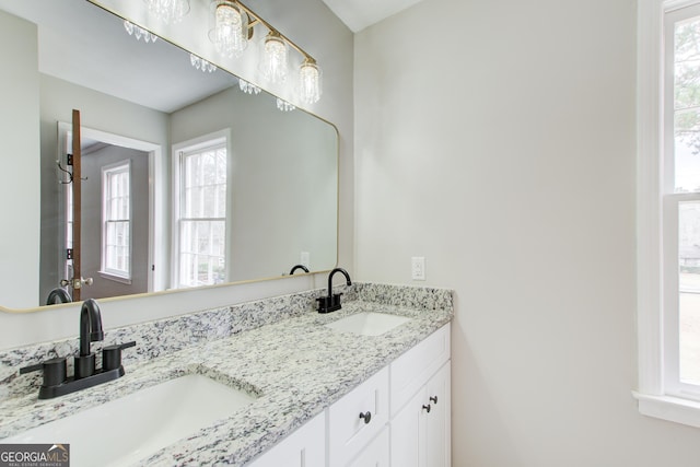 bathroom featuring a healthy amount of sunlight and vanity