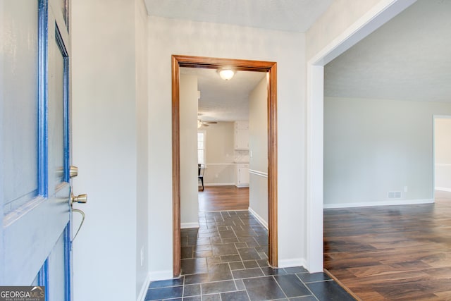 hallway with dark hardwood / wood-style floors