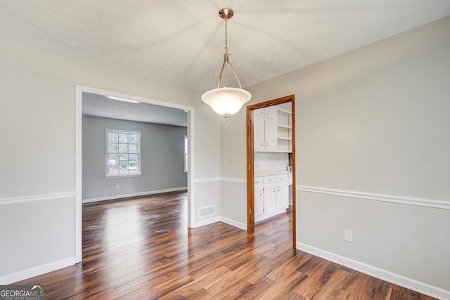 unfurnished dining area with hardwood / wood-style flooring