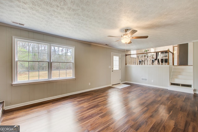 unfurnished room with hardwood / wood-style floors, a textured ceiling, and ceiling fan