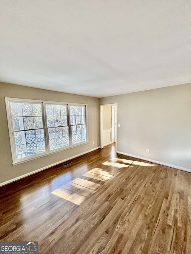 spare room with wood-type flooring