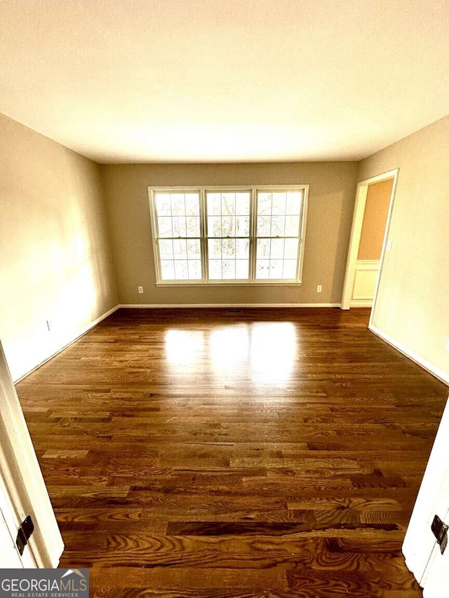 empty room featuring dark hardwood / wood-style flooring