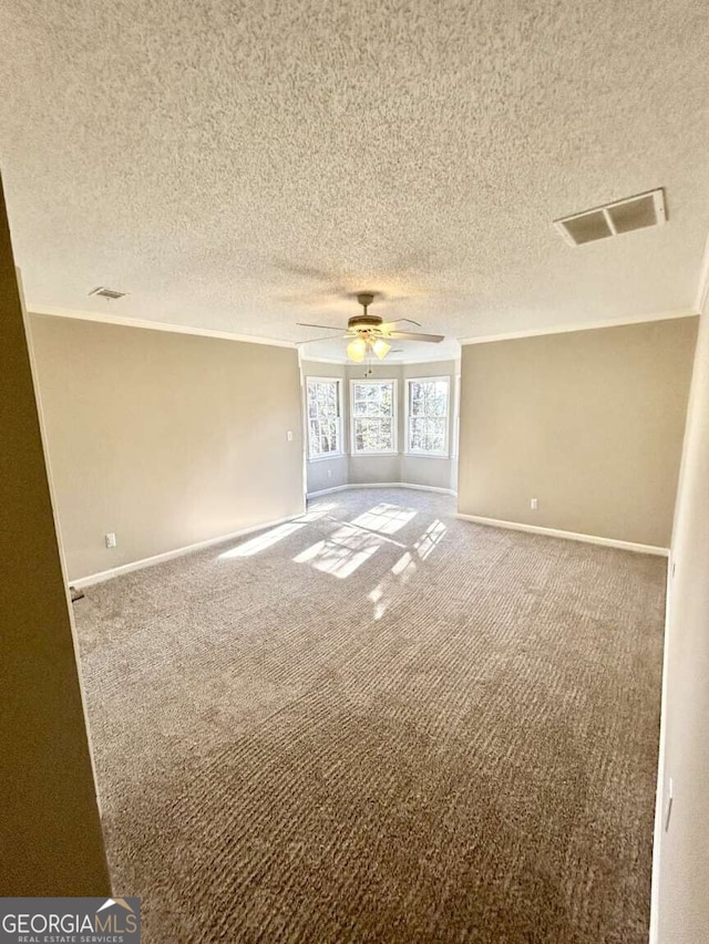 unfurnished room featuring carpet flooring, a textured ceiling, and ceiling fan