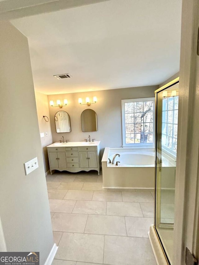 bathroom featuring vanity, tile patterned flooring, and separate shower and tub