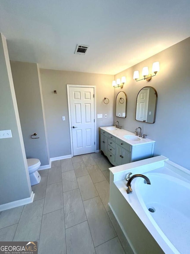 bathroom featuring vanity, toilet, and a bath