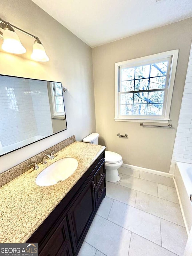 bathroom featuring vanity, tile patterned floors, and toilet