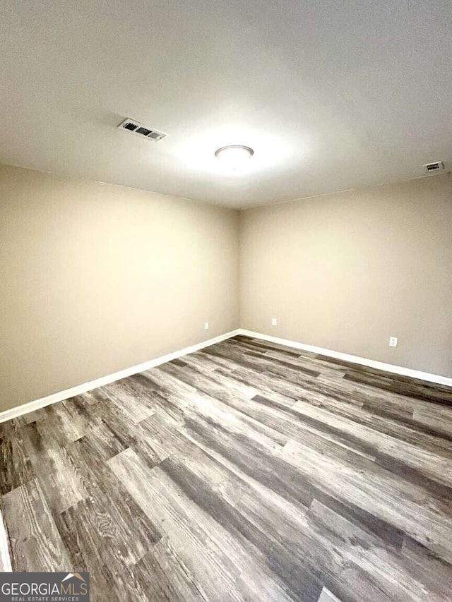 empty room with hardwood / wood-style flooring