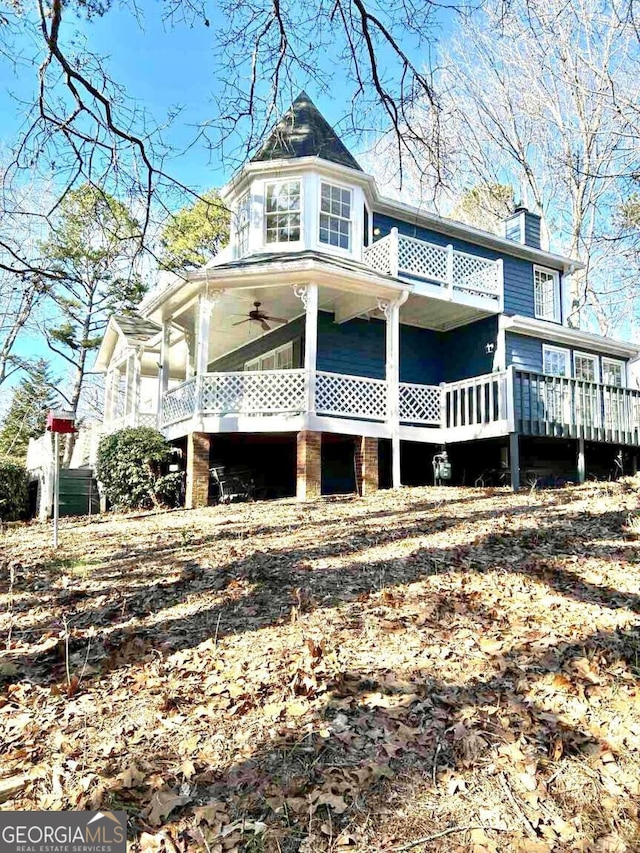 exterior space featuring ceiling fan