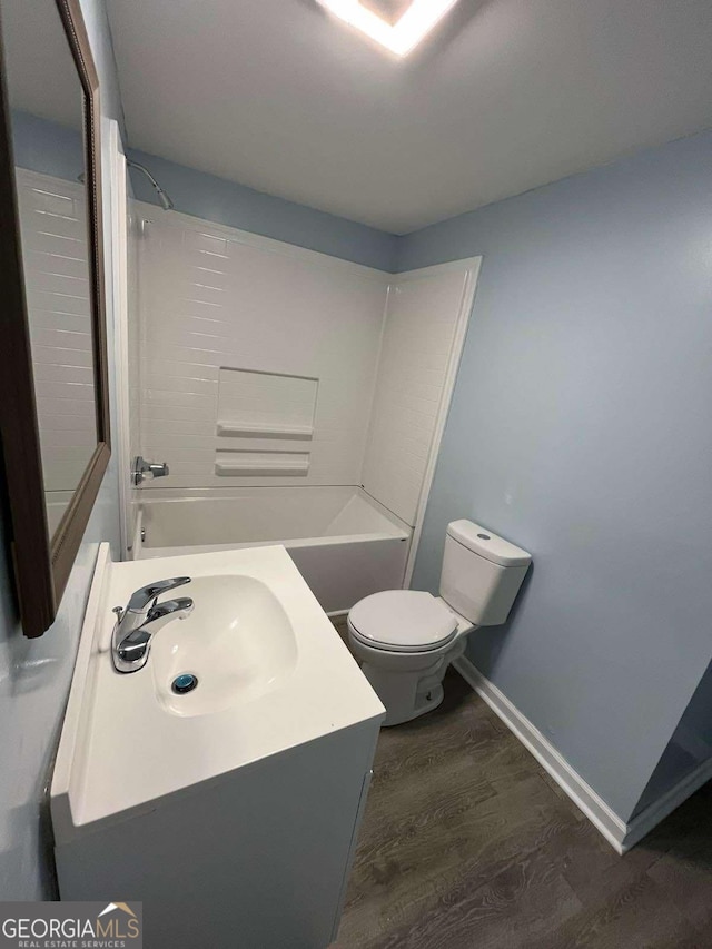 full bathroom with vanity, hardwood / wood-style floors, shower / bathtub combination, and toilet