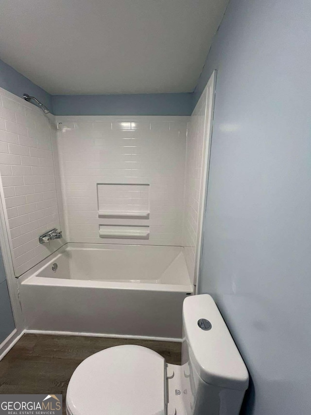 bathroom with shower / bathing tub combination, hardwood / wood-style flooring, and toilet