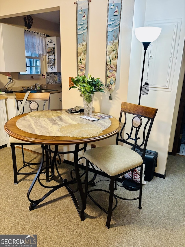 carpeted dining space with sink