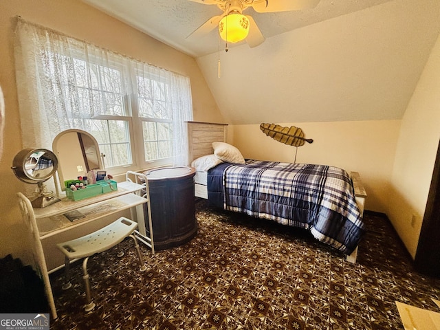 bedroom featuring ceiling fan, vaulted ceiling, and a textured ceiling