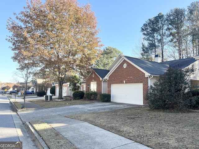 view of front of house with an attached garage, brick siding, a shingled roof, concrete driveway, and a chimney