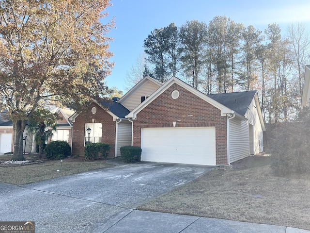 view of front of home with driveway, an attached garage, and brick siding