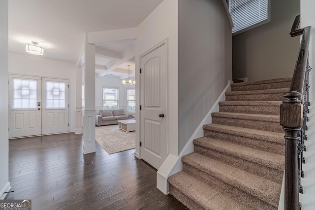 entrance foyer with dark wood-type flooring, french doors, coffered ceiling, beamed ceiling, and decorative columns