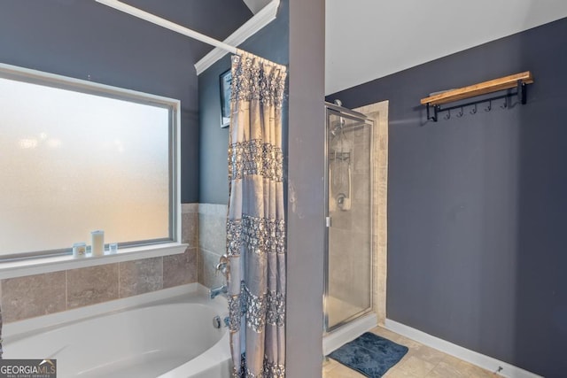 bathroom with a healthy amount of sunlight and independent shower and bath