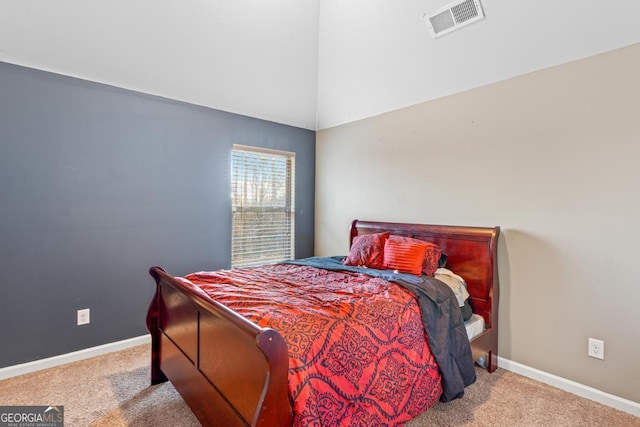 carpeted bedroom featuring lofted ceiling