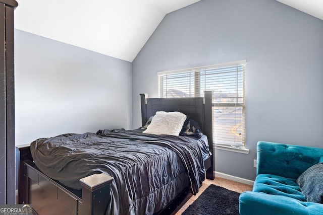 bedroom with lofted ceiling and light colored carpet