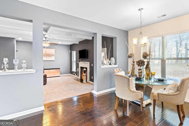 dining space with beamed ceiling, coffered ceiling, ceiling fan with notable chandelier, and hardwood / wood-style floors