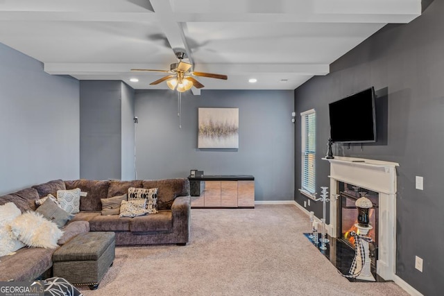 carpeted living room with beamed ceiling and ceiling fan