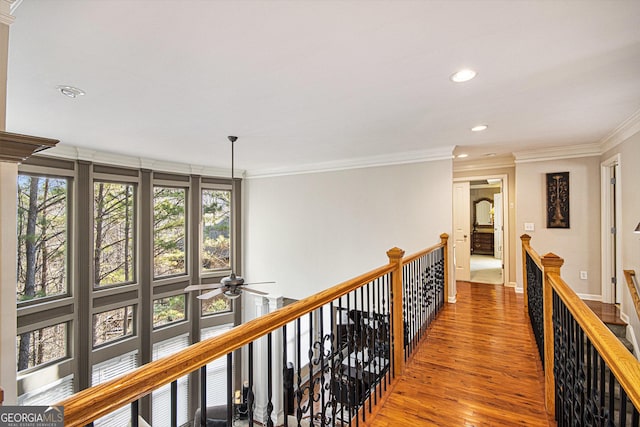 hallway with hardwood / wood-style floors and ornamental molding