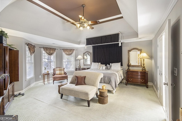 bedroom with crown molding, ceiling fan, carpet flooring, and a raised ceiling