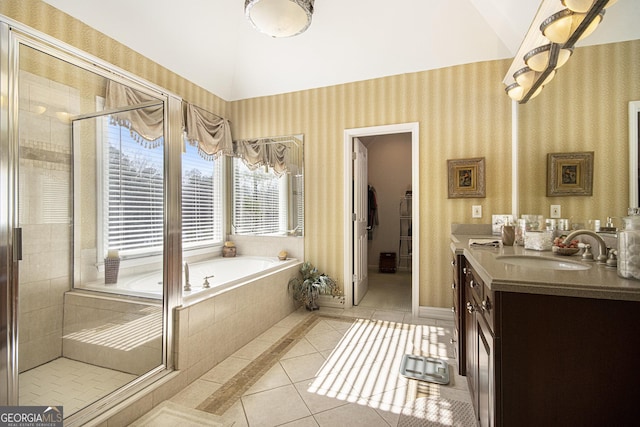 bathroom featuring tile patterned flooring, vanity, vaulted ceiling, and shower with separate bathtub