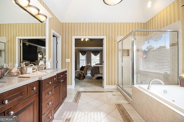 bathroom featuring vanity, lofted ceiling, tile patterned floors, and separate shower and tub