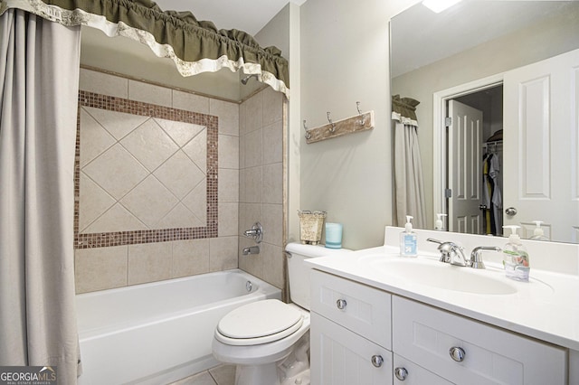 full bathroom with tile patterned floors, vanity, toilet, and tiled shower / bath combo