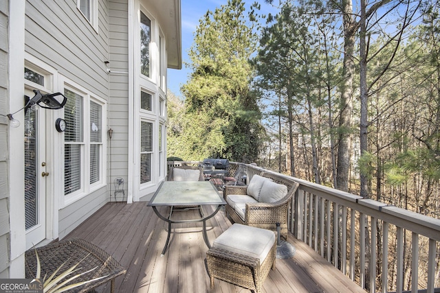 wooden deck featuring a grill and outdoor lounge area