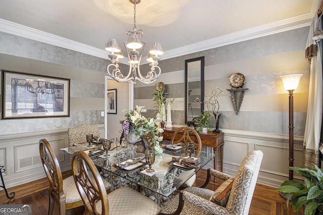 dining area featuring an inviting chandelier, dark wood-type flooring, and ornamental molding