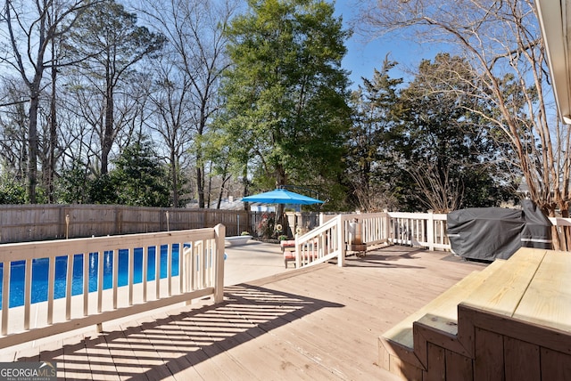 wooden terrace featuring grilling area and a covered pool