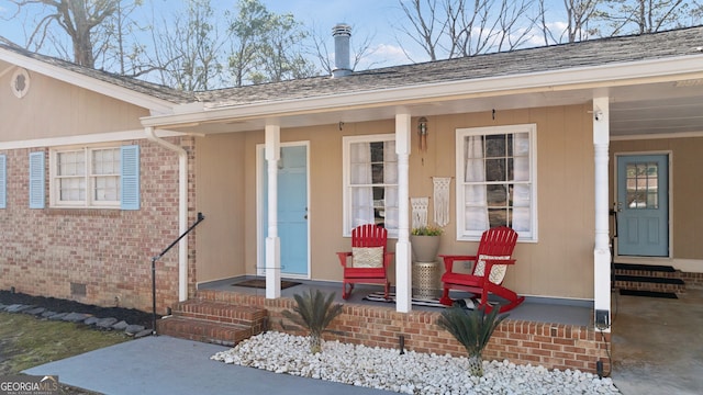 view of exterior entry featuring covered porch