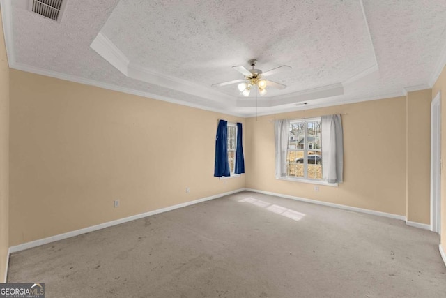 spare room with ceiling fan, a tray ceiling, carpet, and a textured ceiling