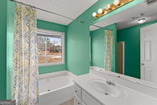 bathroom with vanity and a textured ceiling