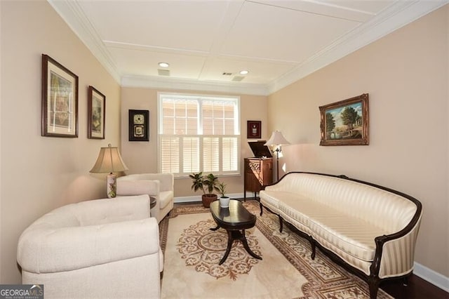 living area featuring coffered ceiling and ornamental molding