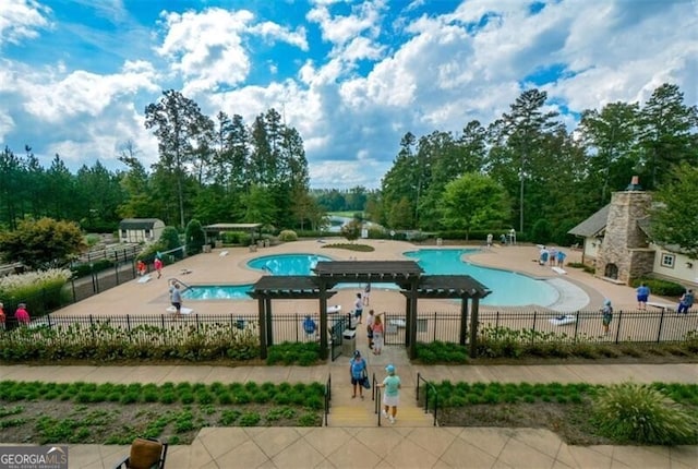 view of swimming pool with a patio area and a pergola