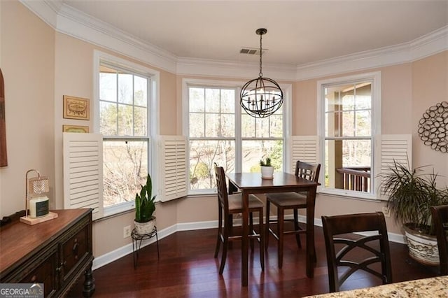 dining area featuring a notable chandelier, plenty of natural light, and dark hardwood / wood-style floors