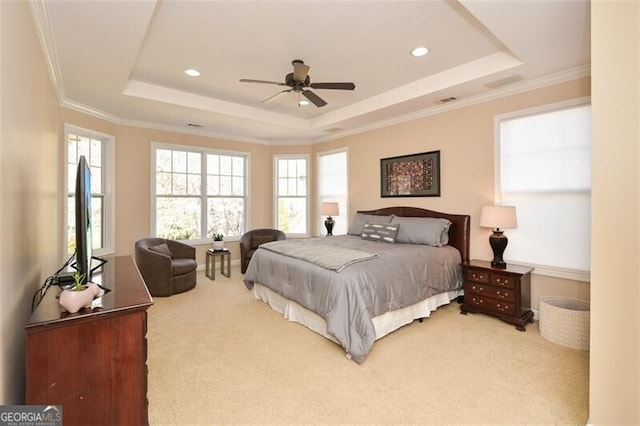 bedroom featuring crown molding, carpet, ceiling fan, and a tray ceiling