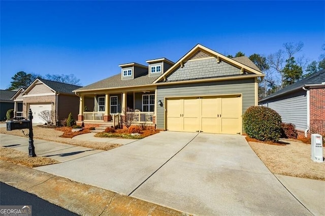 craftsman-style house featuring a garage and covered porch