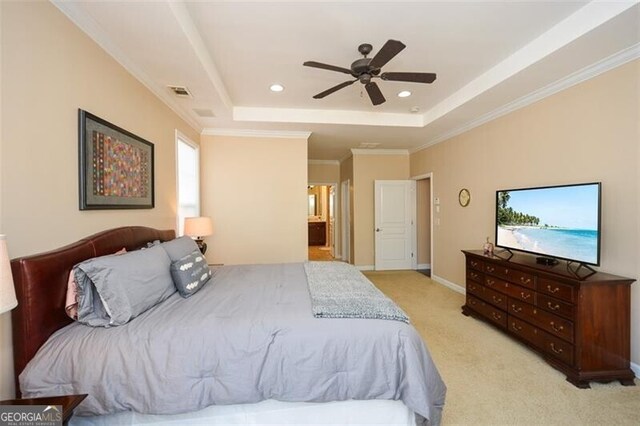 carpeted bedroom with crown molding, a tray ceiling, and ceiling fan