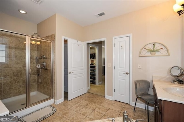 bathroom featuring vanity, tile patterned floors, and walk in shower