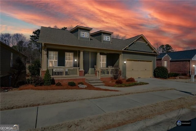 view of front of property with a porch and a garage