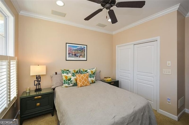 carpeted bedroom featuring multiple windows, ornamental molding, and a closet